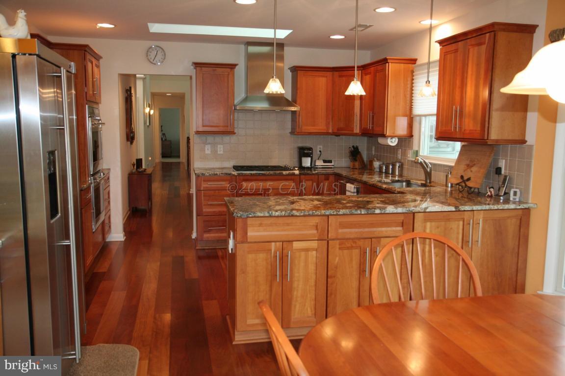 5607 Lone Pine Road Rhodesdale, MD 21659 - Photo 11 of 38 a kitchen with stainless steel appliances granite countertop a refrigerator a stove and a sink