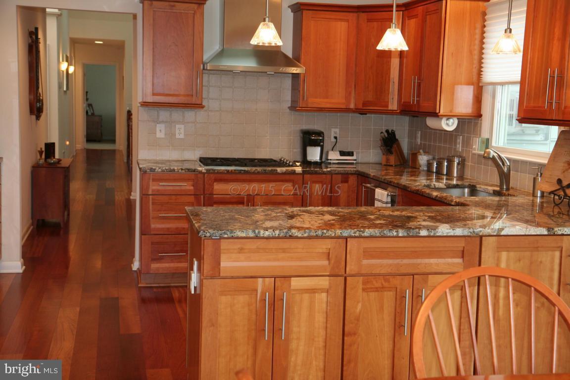 5607 Lone Pine Road Rhodesdale, MD 21659 - Photo 12 of 38 a kitchen with stainless steel appliances granite countertop a sink a stove and a microwave