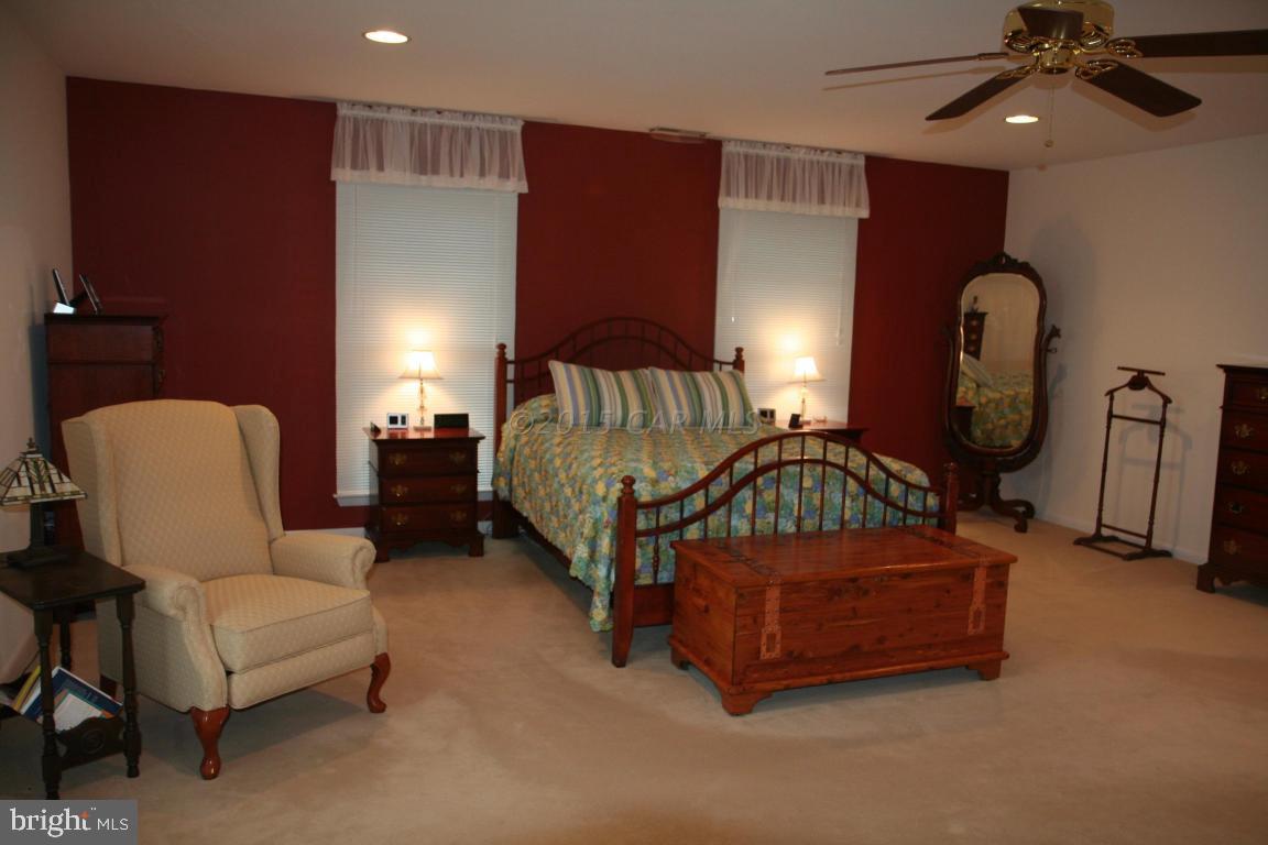 5607 Lone Pine Road Rhodesdale, MD 21659 - Photo 14 of 38 a bedroom with bed couch and window