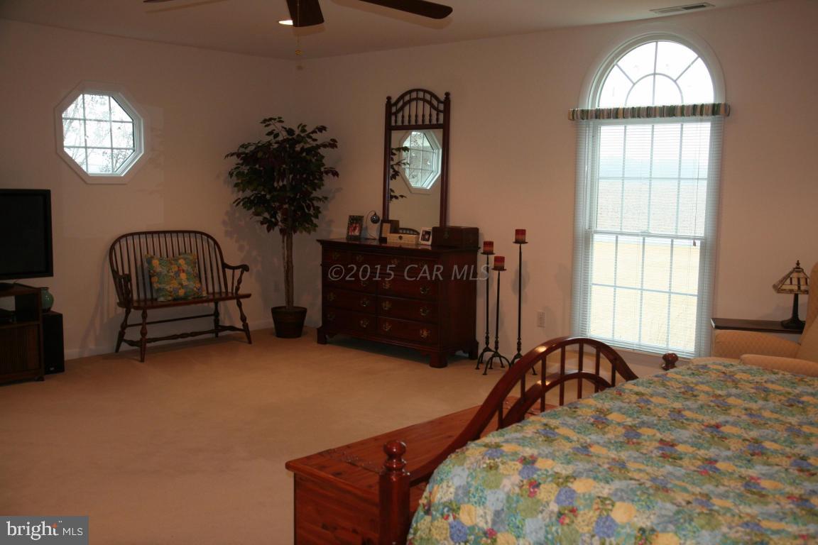 5607 Lone Pine Road Rhodesdale, MD 21659 - Photo 15 of 38 a bedroom with a bed window and dresser