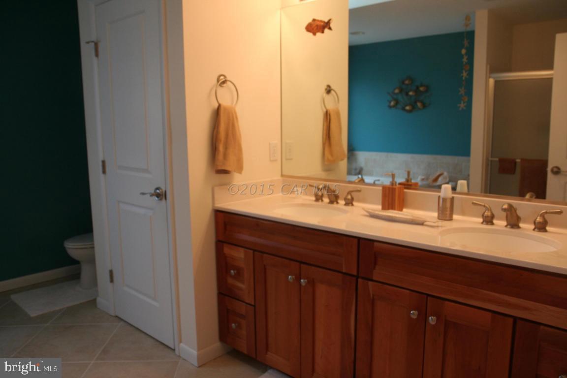 5607 Lone Pine Road Rhodesdale, MD 21659 - Photo 18 of 38 a bathroom with a double vanity sink and a mirror