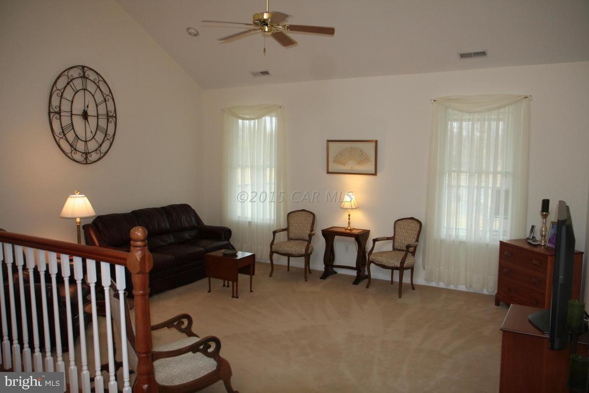 5607 Lone Pine Road Rhodesdale, MD 21659 - Photo 3 of 38 a living room with furniture a window and a chandelier