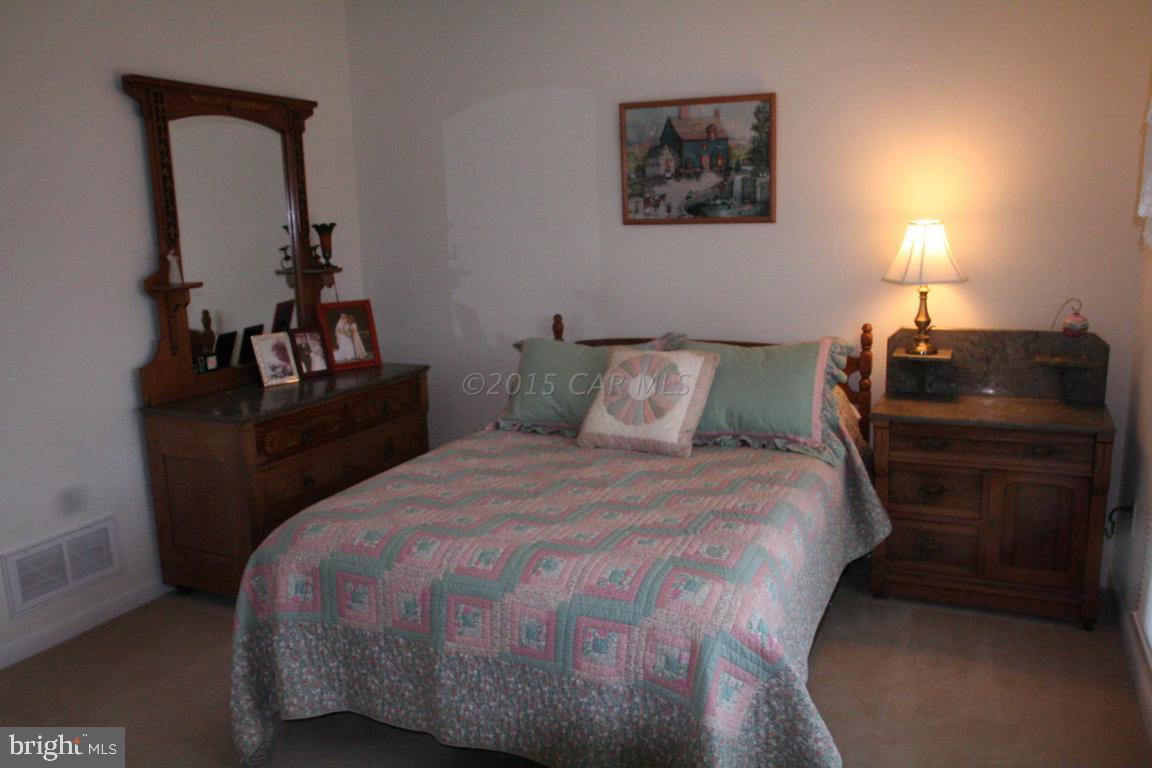 5607 Lone Pine Road Rhodesdale, MD 21659 - Photo 21 of 38 a bedroom with a bed and a dresser