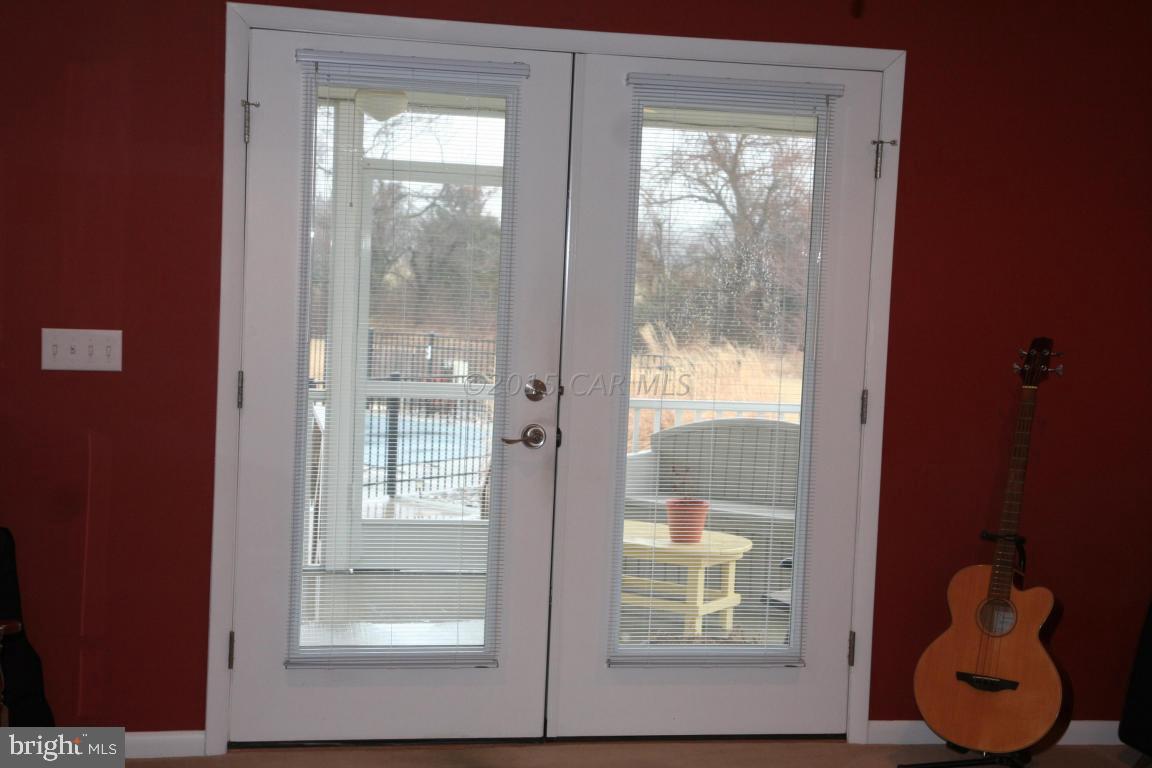 5607 Lone Pine Road Rhodesdale, MD 21659 - Photo 9 of 38 a view of a glass door with a glass door and a window
