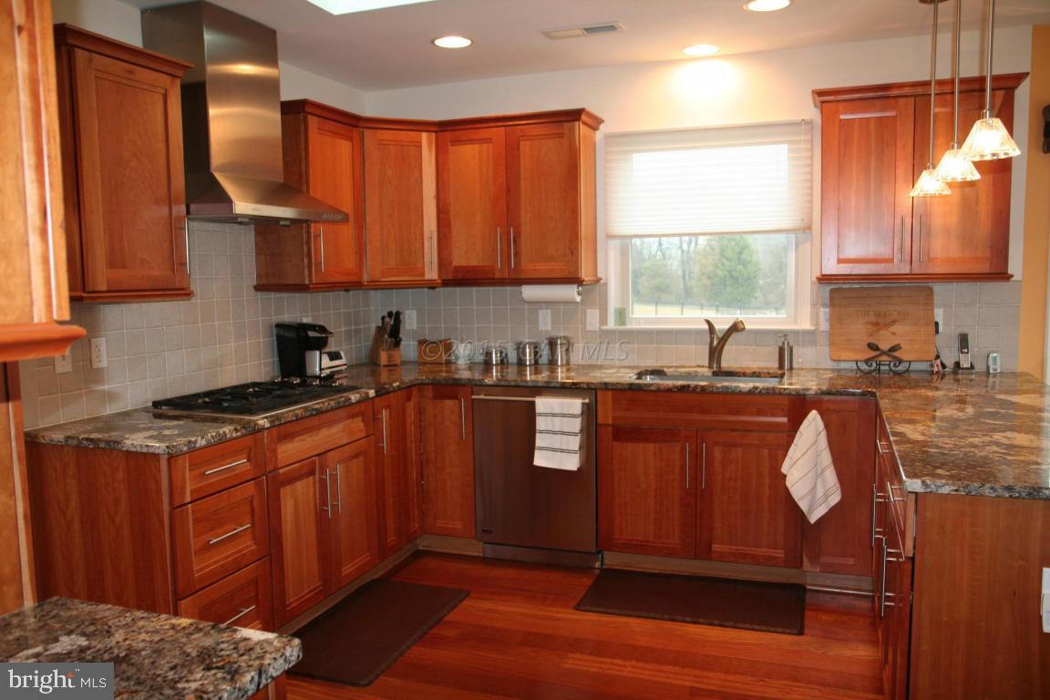 5607 Lone Pine Road Rhodesdale, MD 21659 - Photo 10 of 38 a kitchen with stainless steel appliances granite countertop wooden cabinets a sink and a stove