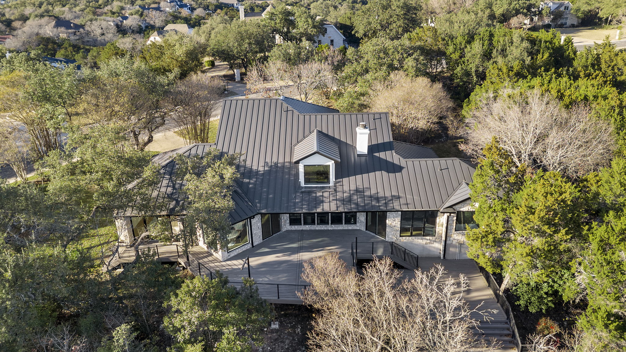 701 Furlong Drive Austin, TX 78746 - Photo 36 of 40 an aerial view of a house with swimming pool and large trees