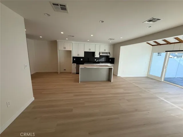 a kitchen with stainless steel appliances a refrigerator and a stove top oven