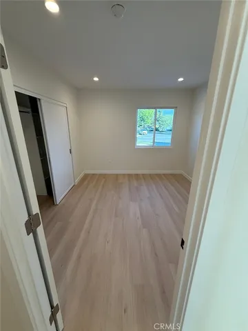 a view of a hallway with wooden floor and a hallway