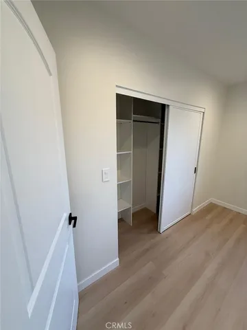 a bathroom with a sink a toilet a mirror and shower