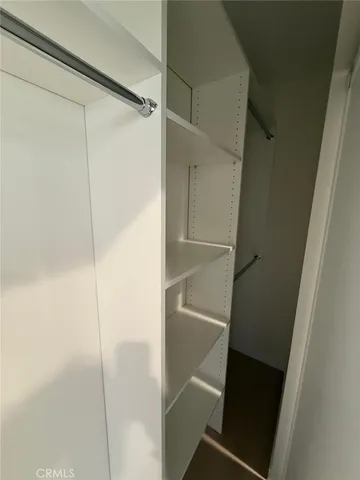 a bathroom with a granite countertop sink a mirror and a toilet