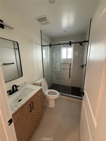 a view of an empty room and wooden floor