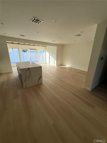 a view of a room with wooden floor and staircase