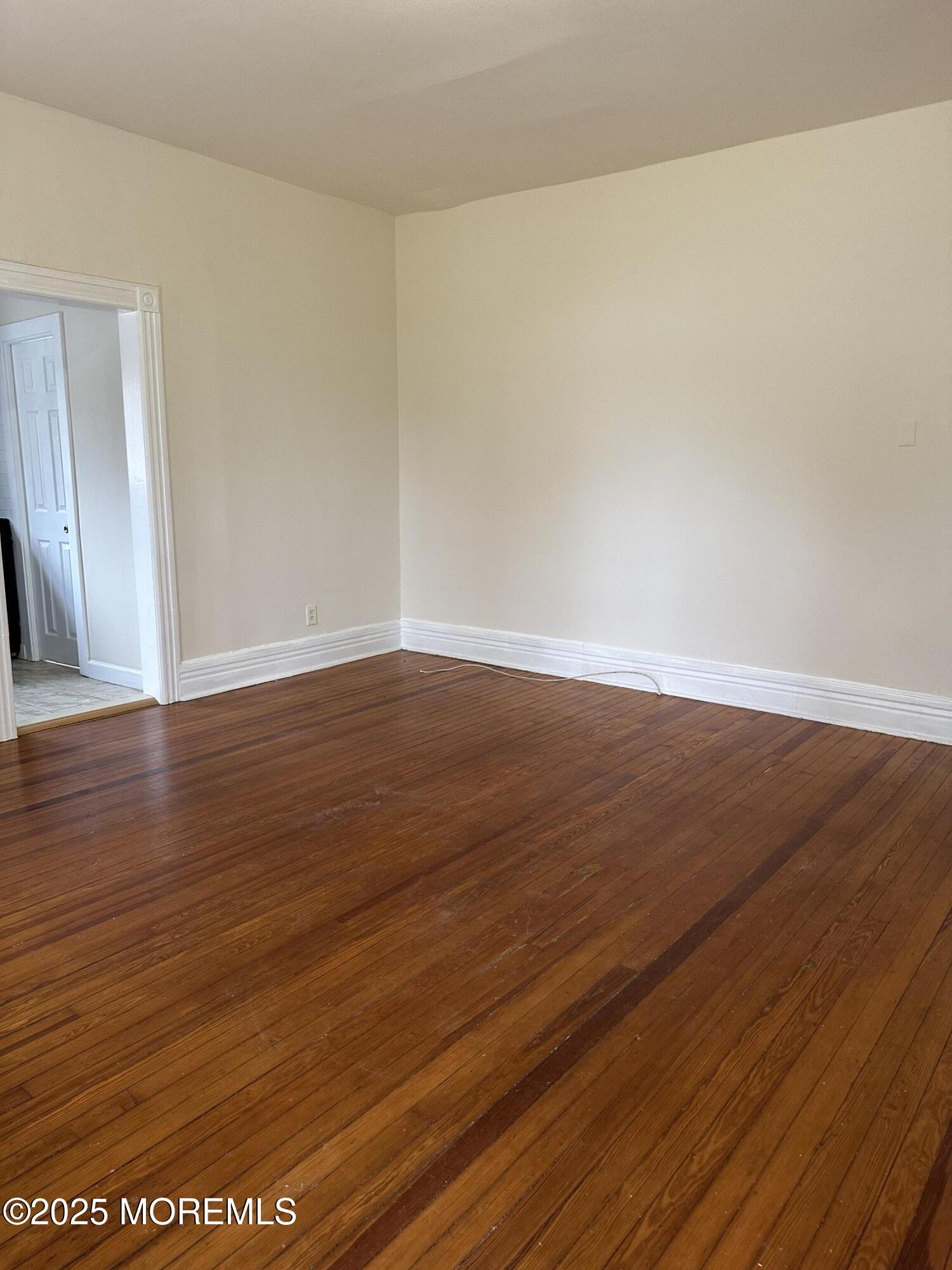348 Cedar Avenue, Unit 3 Long Branch, NJ 07740 - Photo 4 of 9 a view of an empty room with wooden floor