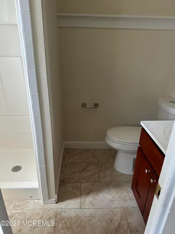 a bathroom with a toilet and a shower