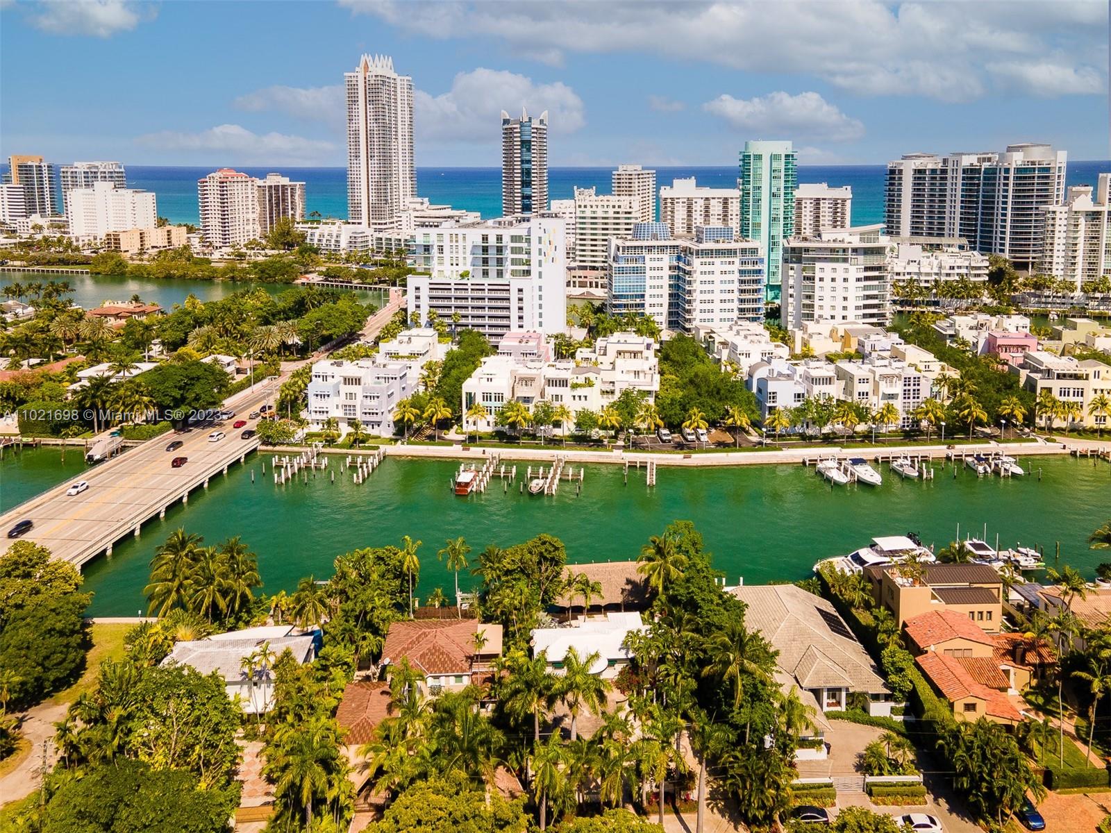 6145 Pine Tree Drive Miami Beach, FL 33140 - Photo 11 of 13 a view of a lake with a city