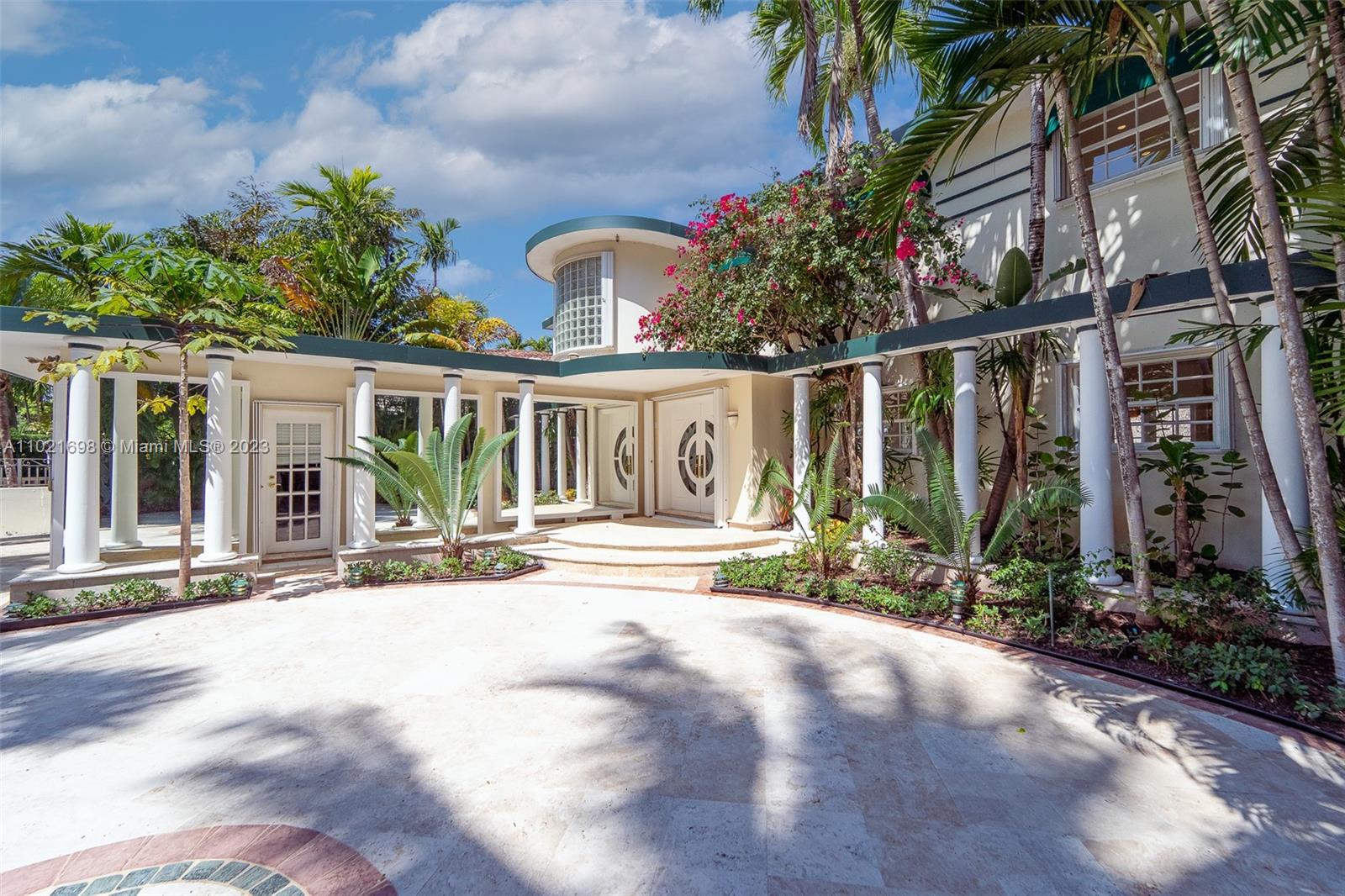 6145 Pine Tree Drive Miami Beach, FL 33140 - Photo 5 of 13 a view of palm trees in front of a building