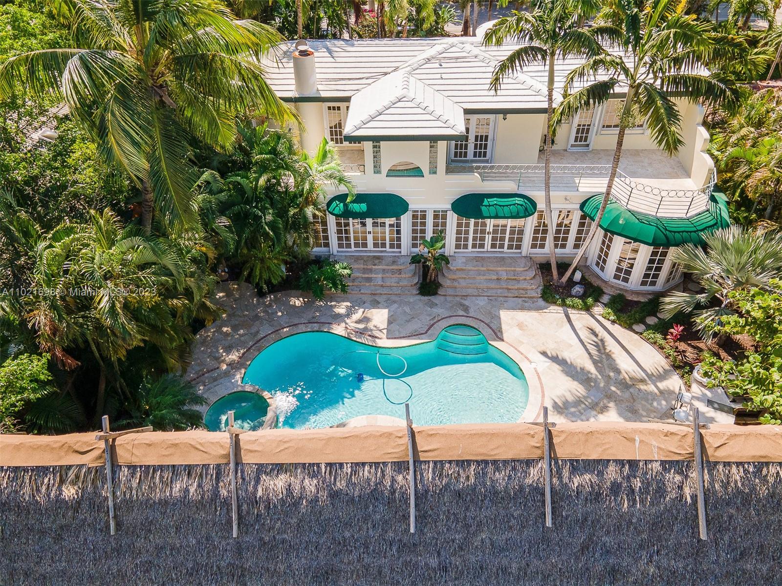 6145 Pine Tree Drive Miami Beach, FL 33140 - Photo 9 of 13 a house with swimming pool in front of it