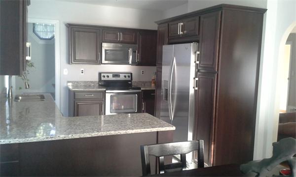 543 Jackson Street Fall River, MA 02721 - Photo 2 of 13 a kitchen with granite countertop a refrigerator and a stove top oven