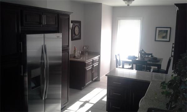 543 Jackson Street Fall River, MA 02721 - Photo 3 of 13 a kitchen with kitchen island a counter top space cabinets and stainless steel appliances