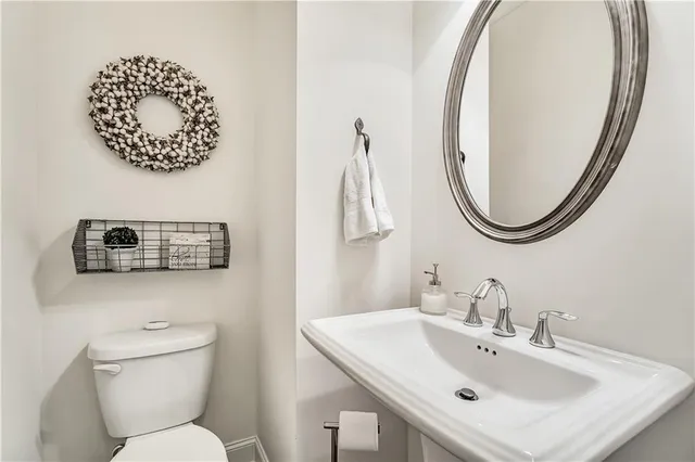 a very nice looking kitchen with wooden floor and a view of a living room