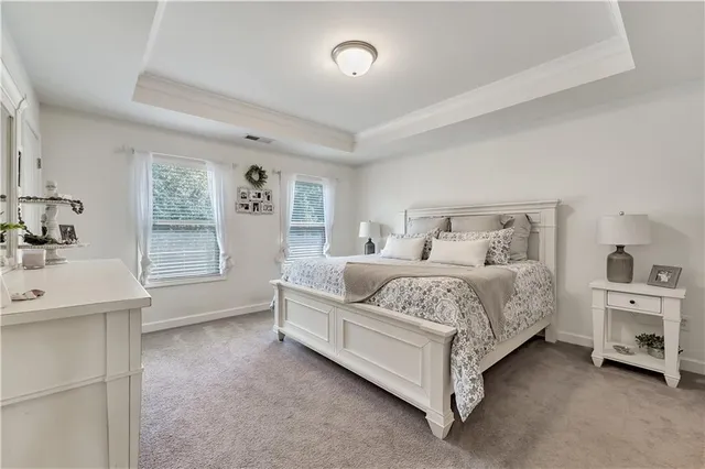 a bedroom with a bed and a night stand