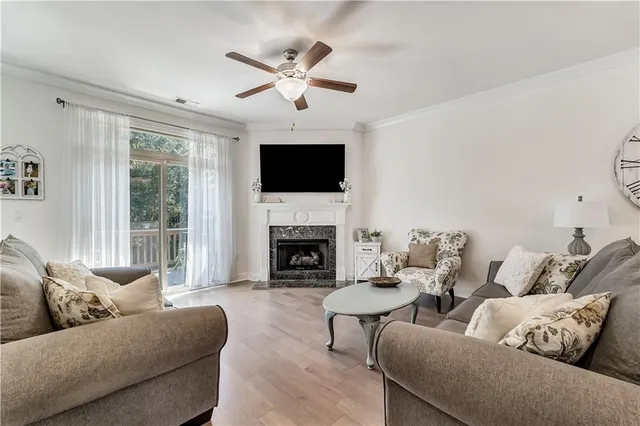 a living room with furniture a flat screen tv and a fireplace