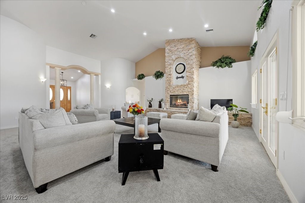 640 Quail Covey Road Henderson, NV 89002 - Photo 6 of 75 Living area featuring light carpet, a fireplace, lofted ceiling, and recessed lighting