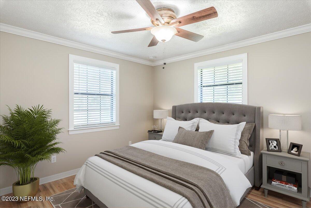 1575 Hardy Padgett Road Jacksonville, FL 32234 - Photo 16 of 43 a bedroom with a bed and a chandelier