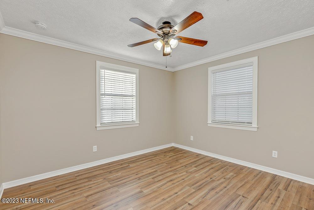 1575 Hardy Padgett Road Jacksonville, FL 32234 - Photo 17 of 43 a view of an empty room with wooden floor and a window
