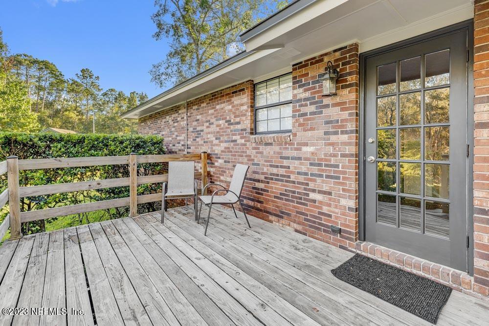 1575 Hardy Padgett Road Jacksonville, FL 32234 - Photo 26 of 43 a roof deck with table and chairs and wooden floor