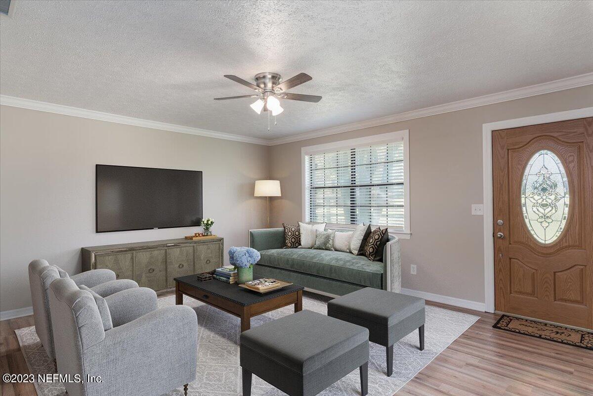 1575 Hardy Padgett Road Jacksonville, FL 32234 - Photo 6 of 43 a living room with furniture a large window and a flat screen tv
