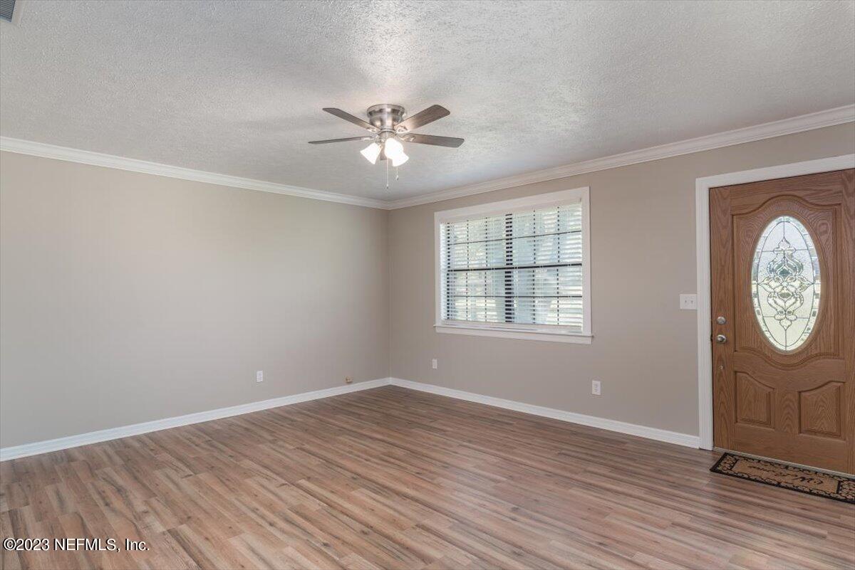 1575 Hardy Padgett Road Jacksonville, FL 32234 - Photo 7 of 43 wooden floor in an empty room with a window