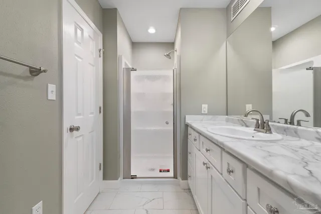 a spacious bathroom with a granite countertop sink mirror and double