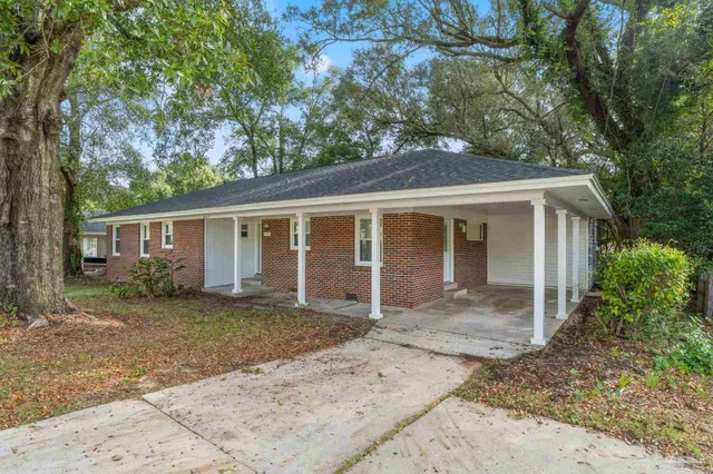 front view of a house with a tree in front of it