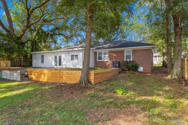 a view of house with a yard