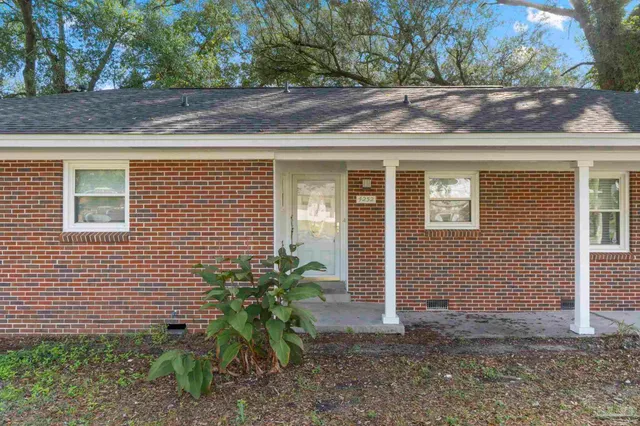 a view of a house with a yard and plants