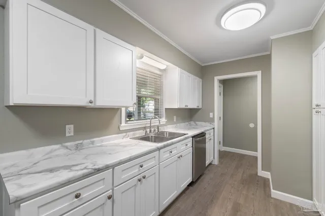 a kitchen with a sink cabinets and window
