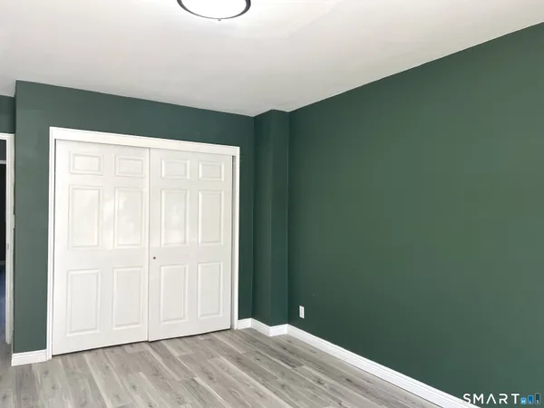 an empty room with wooden floor