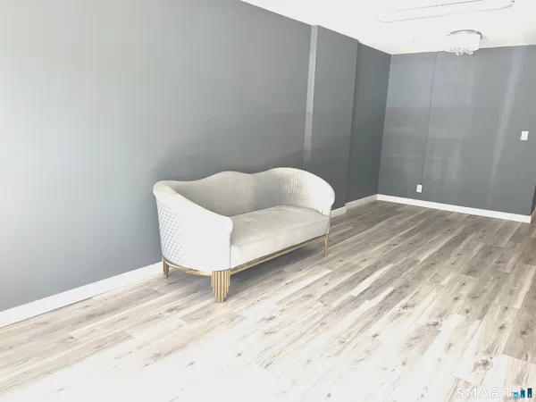 a view of a bedroom with wooden floor