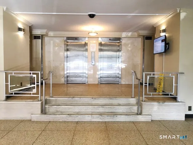 a lobby with furniture and potted plant