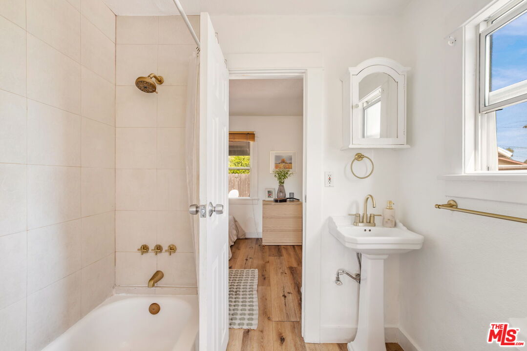 414 Raymond Drive Pasadena, CA 91107 - Photo 13 of 20 a bathroom with a sink a mirror and a shower