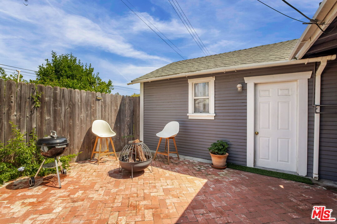 414 Raymond Drive Pasadena, CA 91107 - Photo 16 of 20 a view of a chairs and table in backyard