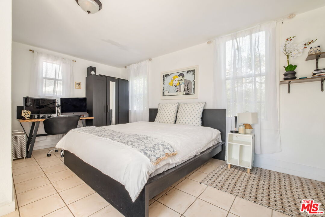 414 Raymond Drive Pasadena, CA 91107 - Photo 18 of 20 a bedroom with a bed and a painting on the wall