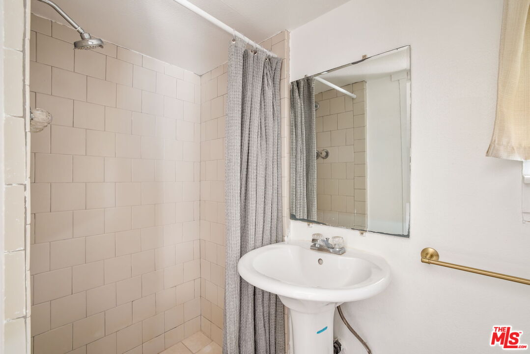 414 Raymond Drive Pasadena, CA 91107 - Photo 19 of 20 a bathroom with a sink a shower and a mirror