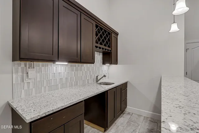 a kitchen with granite countertop cabinets and sink