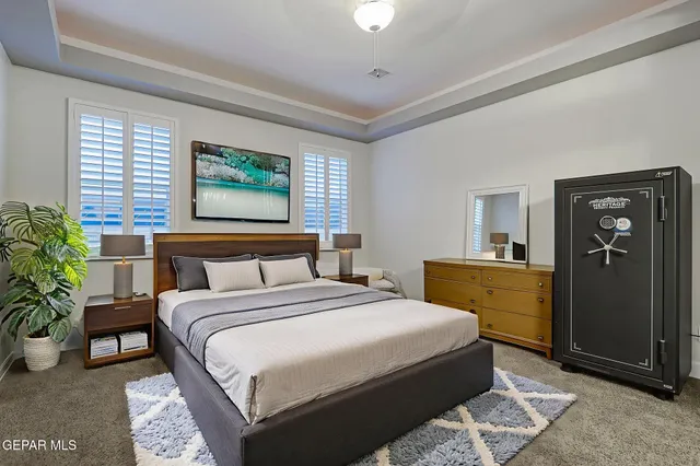 a bedroom with a bed and a potted plant