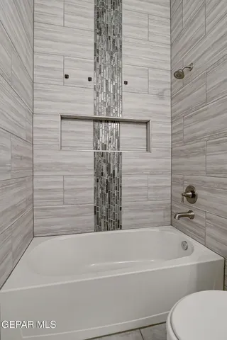 a bathroom with a toilet and a bathtub