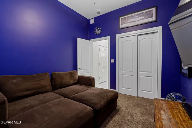 a blue couch sitting in a living room with a couch