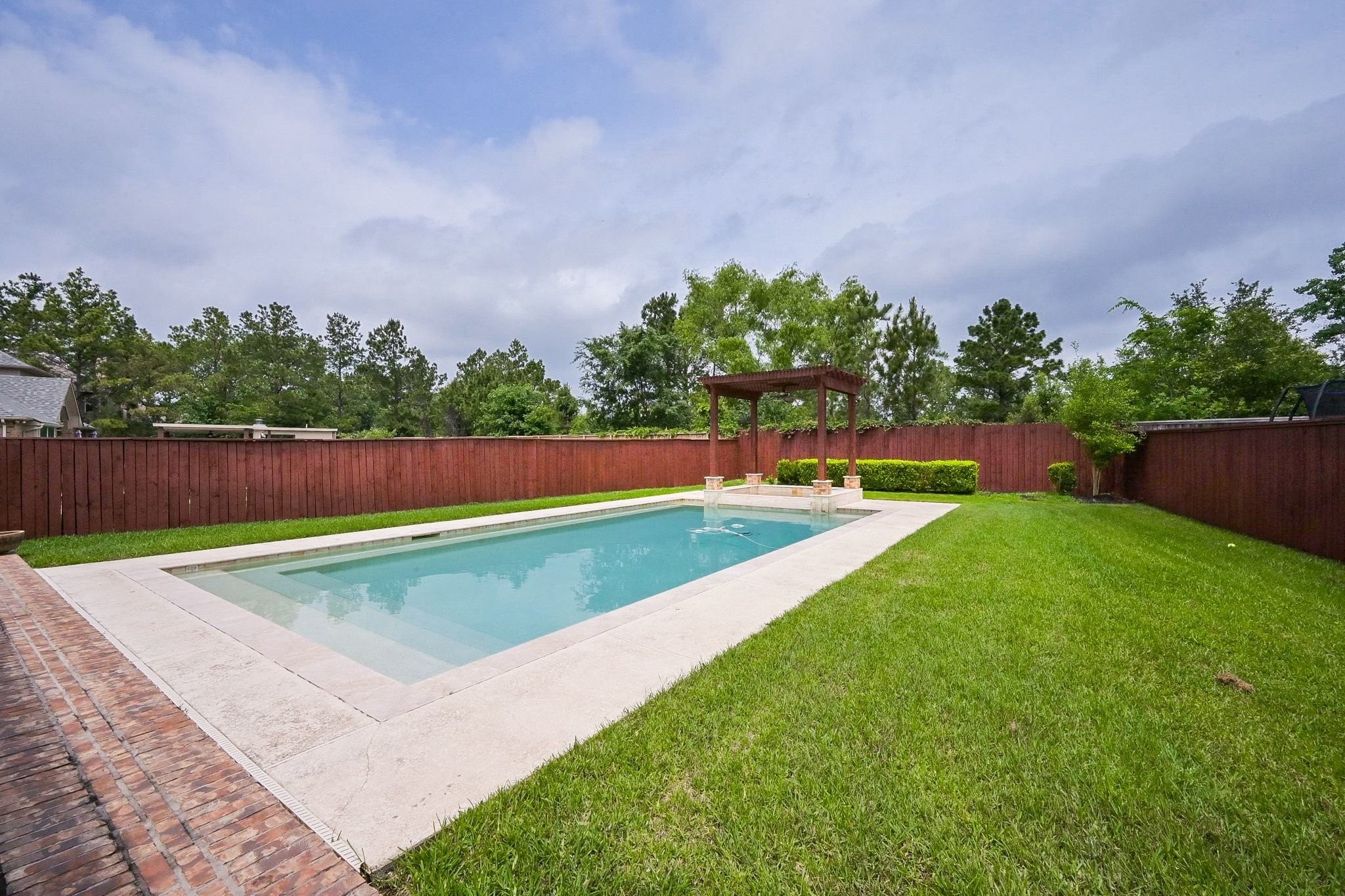 107 North Bacopa Drive Spring, TX 77389 - Photo 2 of 34 Spacious backyard with a beautifully positioned pool and plenty of room to enjoy outdoor living and gatherings.