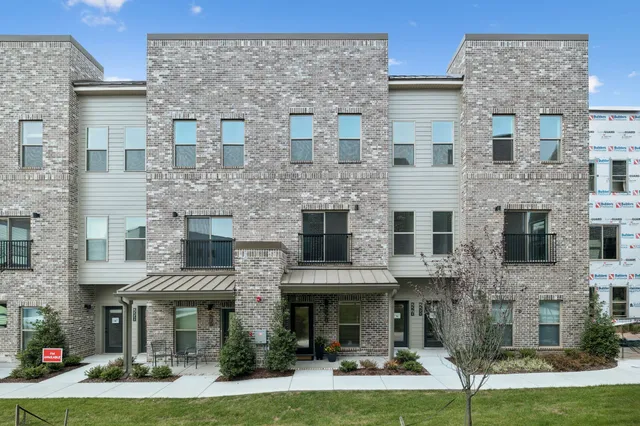a front view of a brick building with yard